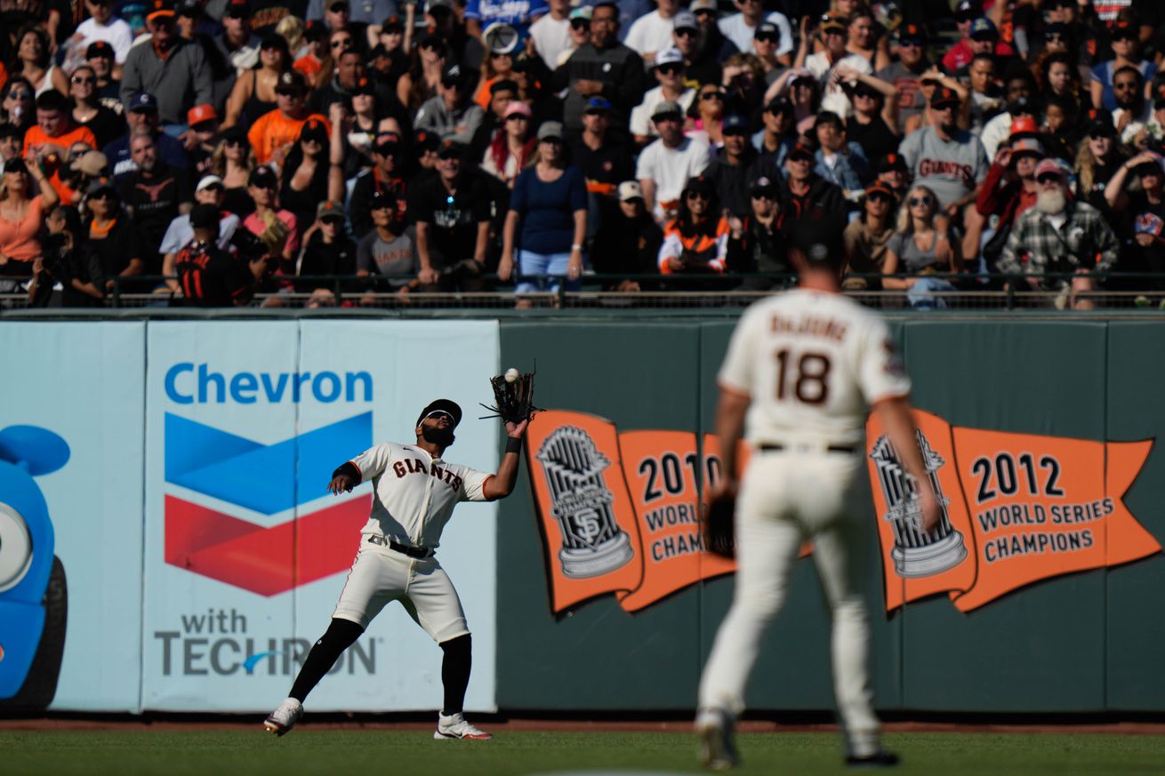 View from behind the pitcher of Heliot Ramos catching a fly ball. 