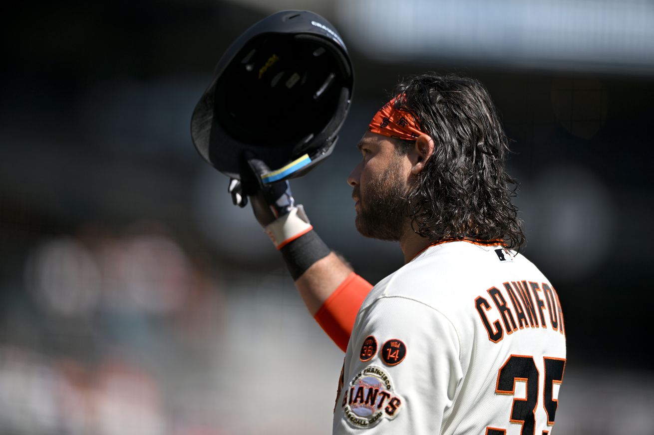 Brandon Crawford tipping his helmet to the fans in his final Giants game. 