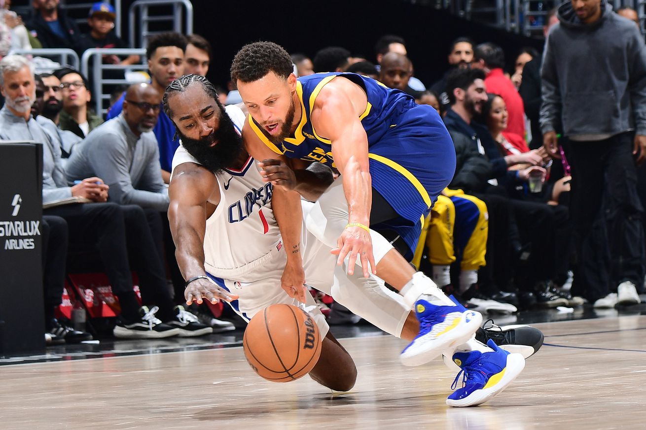 Steph Curry and James Harden diving for a ball. 