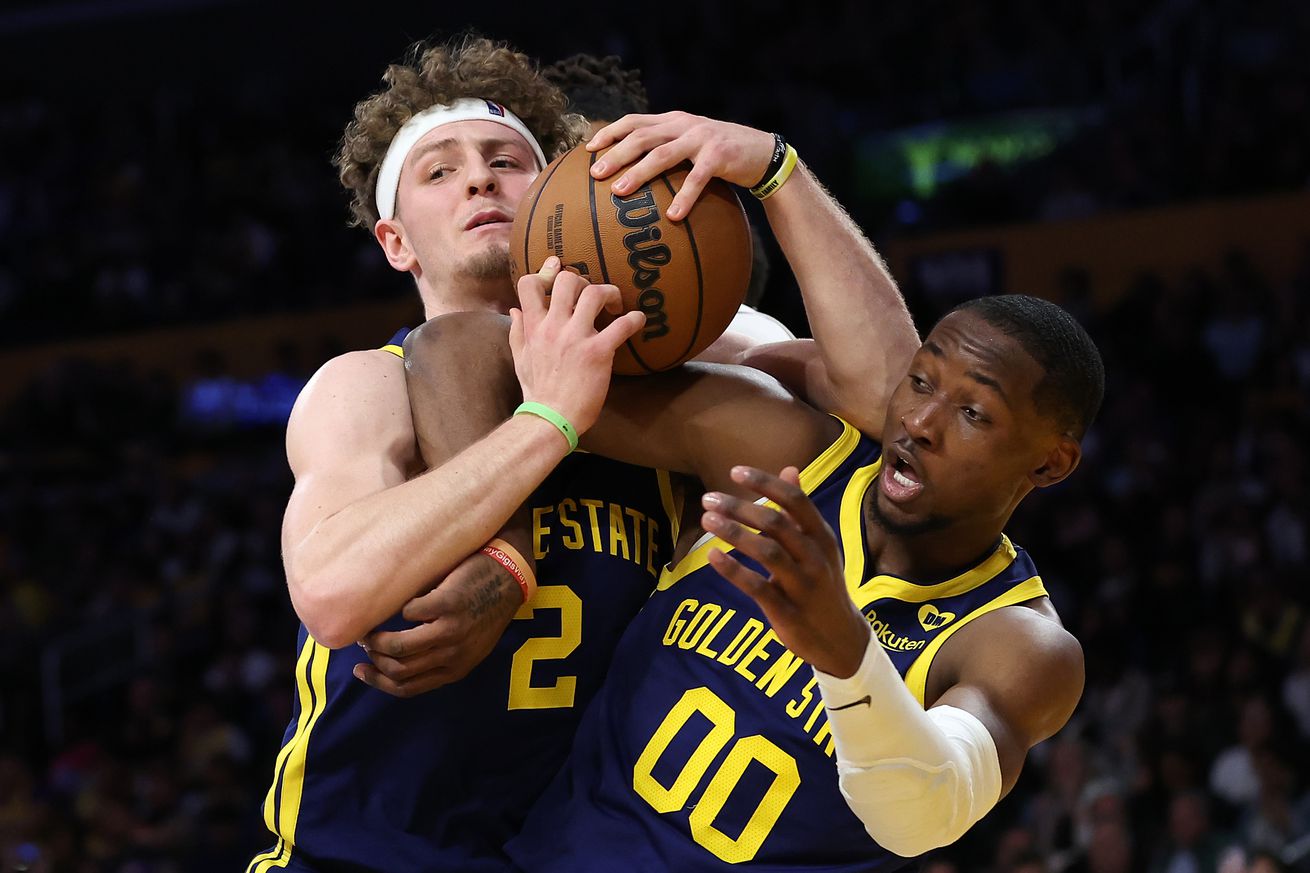 Brandin Podziemski and Jonathan Kuminga getting tangled trying to grab a loose ball. 