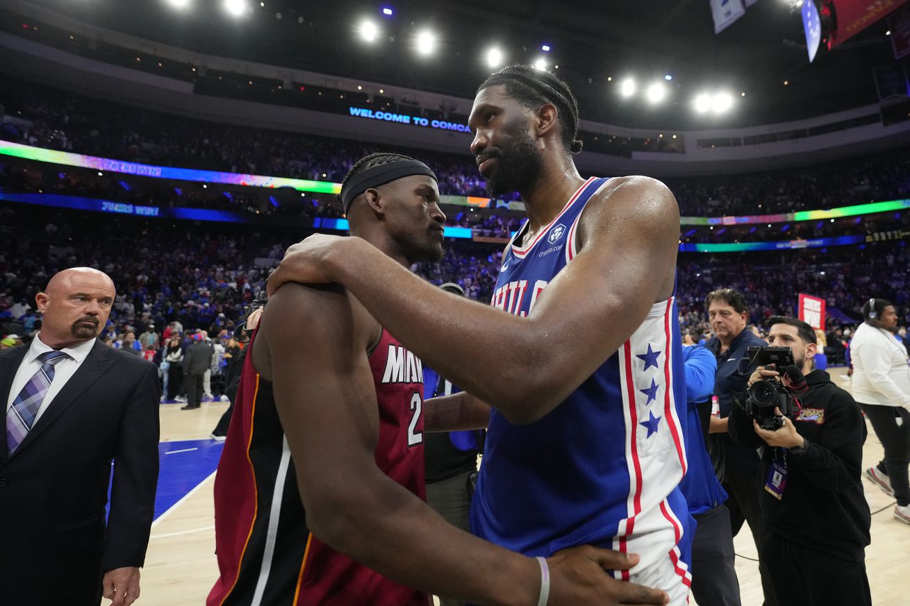 Jimmy Butler III and Joel Embiid embracing.