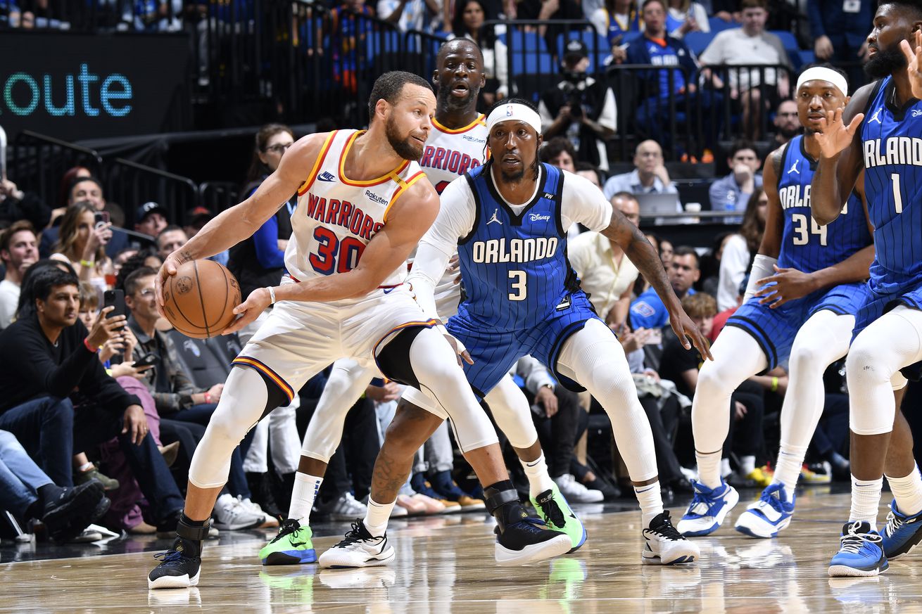 Steph Curry holding the ball and colliding with Kentavious Caldwell-Pope. 