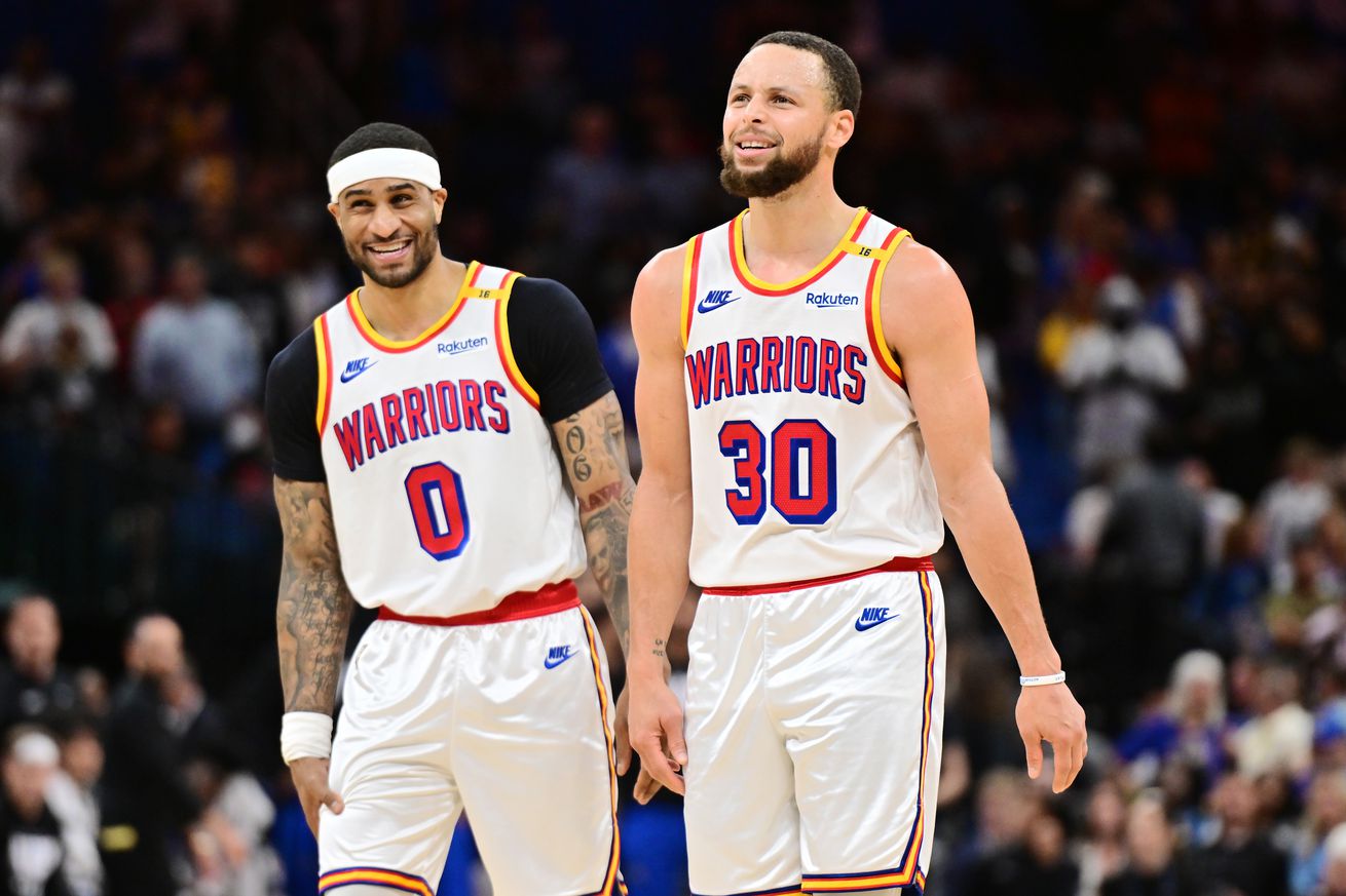 ORLANDO, FLORIDA - FEBRUARY 27: Stephen Curry #30 and Gary Payton II #0 of the Golden State Warriors react in the second half against the Orlando Magic at Kia Center on February 27, 2025 in Orlando, Florida.