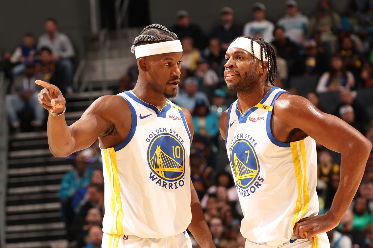 Buddy Hield and Jimmy Butler III talking during a game.