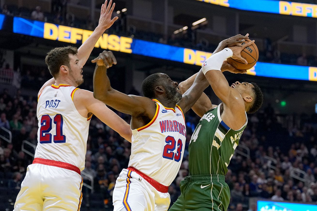 Draymond Green blocking a Giannis Antetokounmpo floater with Quinten Post behind him. 